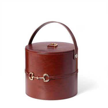 Faux leather ice bucket with lid, tan stitching, gold-tone latch and curved handle.