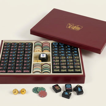 Story & Suns American mahjong set with black tiles and a burgundy display case on a white background
