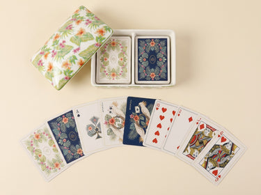 Palm Garden double-deck playing card set displayed with an open tropical floral ceramic box and illustrated cards
