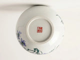 Porcelain globe vase bottom view with blue floral accents and red seal