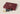 Burgundy vegan leather mahjong case with tonal stitching and a small gold foil tile emblem