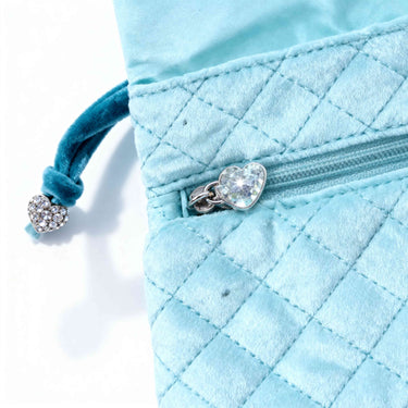 Three zippered inner pockets with heart-shaped charm zipper pullers