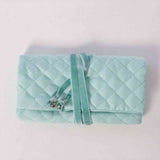 Jewelry roll ring bar secured with decorative rhinestone stoppers