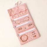 Velvet drawstring closure with rhinestone stopper ends on jewelry roll