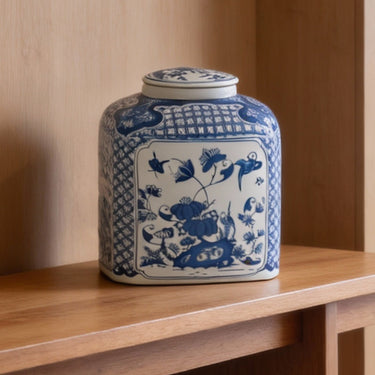 Close-up of hand-painted birds and flowers details on blue and white porcelain jar
