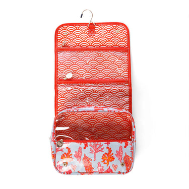 Hanging toiletry bag with coral print and waterproof compartments