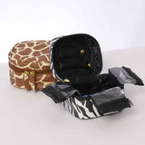 Leopard print vegan leather jewelry pouch opened with organized compartments