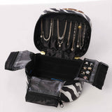 Zippered closure detail on leopard print vegan leather jewelry pouch