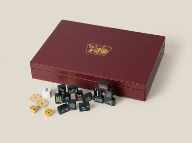 Burgundy vegan leather mahjong case with tonal stitching and a small gold foil tile emblem
