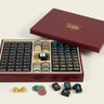 Story & Suns American mahjong set with black tiles and a burgundy display case on a white background