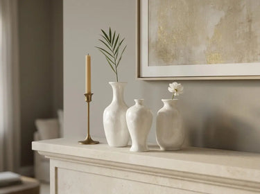 Three crystalline glaze mini vases holding single white flowers and delicate green stems