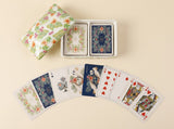Palm Garden double-deck playing card set displayed with an open tropical floral ceramic box and illustrated cards