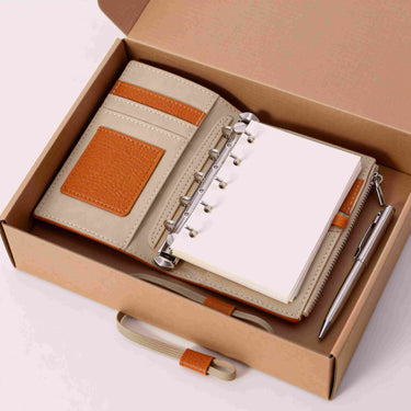 Compact travel notebook wallet in a small bag, ready for a short trip