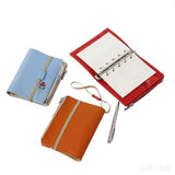 Travel notebook wallet opened showing 50 removable pages and included pen